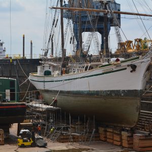 dry docked ship being inspected for maintenance