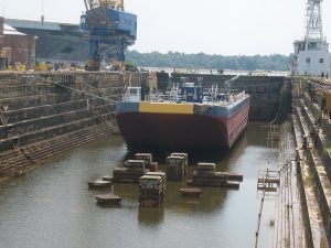 ship in flooding dry dock with blocks and ropes