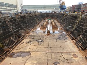 drained dry dock with blocks and crane