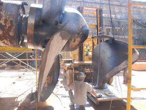 ship propeller being repaired in hangar