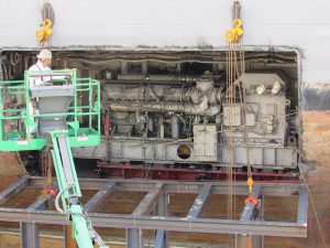 ship rigging process with worker on scaffold examining ship components