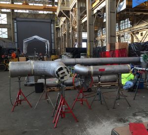 custom metal fabricated pipe system being constructed in warehouse