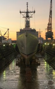 dry docked battleship at dusk front view
