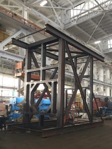 custom metal fabricated component for ship building inside warehouse