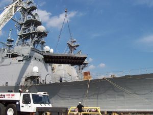 battleship dry docked with crane raised platform