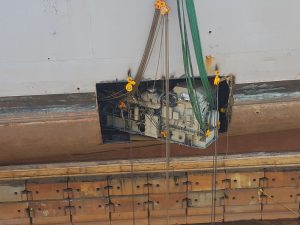 government ship engine being removed for repairs