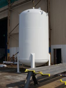 Large metal boiler with paint blasted off