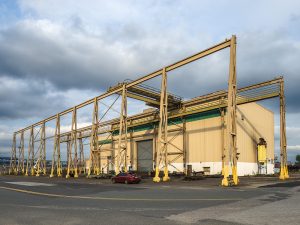 rhoads custom metal fabrication facility exterior view with red car