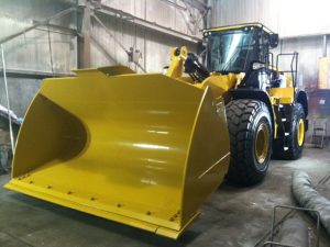 custom fabricated front loader scoop in hangar